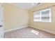 Bedroom with neutral walls and carpet, featuring one window and a ceiling fan at 207 N Hopkins Ave, Spring Hope, NC 27882