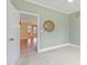 Bedroom with green walls, carpeted floors, ceiling fan and a doorway at 207 N Hopkins Ave, Spring Hope, NC 27882