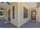 Charming front porch featuring double glass doors, outdoor ceiling fan, and ample light at 207 N Hopkins Ave, Spring Hope, NC 27882