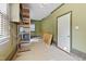 Spacious garage with shelving units and natural light from a window at 207 N Hopkins Ave, Spring Hope, NC 27882