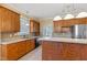 Traditional kitchen with stainless steel appliances, wooden cabinets, tile floors, and ample counter space at 207 N Hopkins Ave, Spring Hope, NC 27882