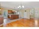 Open kitchen with wood cabinets, stainless steel appliances, and modern lighting fixtures at 207 N Hopkins Ave, Spring Hope, NC 27882