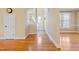 Bright living room with hardwood floors, cream colored walls, and a staircase at 207 N Hopkins Ave, Spring Hope, NC 27882