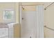Clean shower stall featuring white tile and glass door at 207 N Hopkins Ave, Spring Hope, NC 27882
