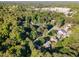 Aerial view of the neighborhood, showcasing the lush greenery, scattered homes, and cityscape in the distance at 241 E Cornwall Rd, Cary, NC 27511