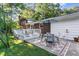 Relaxing backyard patio with an umbrella table set, and a view of the home's brick exterior at 241 E Cornwall Rd, Cary, NC 27511