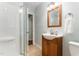 Bathroom featuring a single sink vanity, shower, and neutral color palette at 241 E Cornwall Rd, Cary, NC 27511