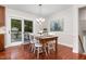 Dining area featuring a dining table, chairs, chandelier, and glass sliding door to outside at 241 E Cornwall Rd, Cary, NC 27511