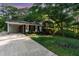 Brick home featuring a carport and a well-manicured lawn with lovely landscaping at 241 E Cornwall Rd, Cary, NC 27511