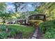 Charming brick home with lush landscaping, healthy green lawn, and decorative walkway at 241 E Cornwall Rd, Cary, NC 27511