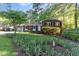 Charming brick home with lush landscaping, healthy green lawn, and decorative walkway at 241 E Cornwall Rd, Cary, NC 27511