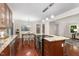 Open concept kitchen featuring a large island, stainless appliances, and wooden cabinets at 241 E Cornwall Rd, Cary, NC 27511