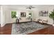 Sun-filled living room featuring hardwood floors, neutral paint, a ceiling fan and many windows to let in the natural light at 241 E Cornwall Rd, Cary, NC 27511