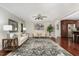 Bright living room featuring neutral furniture, ceiling fan, and hardwood floors at 241 E Cornwall Rd, Cary, NC 27511