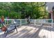 Inviting outdoor deck with comfortable seating and a peaceful view of the backyard and trees at 241 E Cornwall Rd, Cary, NC 27511