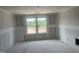 Unfinished bedroom with drywall, concrete floor, and bright windows at 241 Tidal Pool Way, Cary, NC 27519