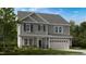 Charming two-story home featuring gray siding, a two-car garage, and a well-manicured lawn at 241 Tidal Pool Way, Cary, NC 27519