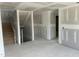 Unfinished foyer showcasing stairs to the second floor, drywall, and a concrete floor at 241 Tidal Pool Way, Cary, NC 27519
