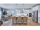 Open-concept kitchen with island seating, stainless steel appliances, and a dining area at 241 Tidal Pool Way, Cary, NC 27519