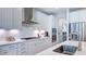 Well-equipped kitchen with white cabinets, a stainless steel range hood, and subway tile backsplash at 241 Tidal Pool Way, Cary, NC 27519