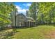 Charming home featuring a well-manicured lawn and a screened-in porch overlooking the backyard at 2513 Myrtle Ln, Hillsborough, NC 27278