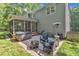 Relaxing backyard with paver patio, hot tub, screened porch, fire pit, comfortable seating, and lush landscaping at 2513 Myrtle Ln, Hillsborough, NC 27278