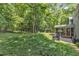 Tranquil backyard featuring a screened porch, patio, and lush greenery, providing a peaceful retreat at 2513 Myrtle Ln, Hillsborough, NC 27278