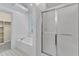 Bright primary bathroom featuring a soaking tub and a separate glass-enclosed shower at 2513 Myrtle Ln, Hillsborough, NC 27278