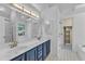 Bathroom with a double sink vanity, a large mirror, and access to a walk-in closet at 2513 Myrtle Ln, Hillsborough, NC 27278