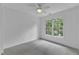 Bright bedroom features neutral carpet, ceiling fan, and a large window with a view at 2513 Myrtle Ln, Hillsborough, NC 27278