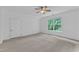Neutral bedroom with carpet, ceiling fan, large window, and a closet door at 2513 Myrtle Ln, Hillsborough, NC 27278