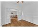 Bonus room with hardwood floors and white walls with glass french doors that lead to the dining room at 2513 Myrtle Ln, Hillsborough, NC 27278