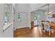 Bright foyer featuring hardwood floors, white walls, and a view into the dining room and entry door at 2513 Myrtle Ln, Hillsborough, NC 27278