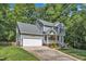 Charming two-story home with a two-car garage, bright yellow front door and a welcoming front lawn area at 2513 Myrtle Ln, Hillsborough, NC 27278