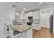 Kitchen featuring a breakfast bar, stainless steel appliances and light fixtures at 2513 Myrtle Ln, Hillsborough, NC 27278