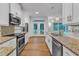 Beautiful kitchen featuring stainless steel appliances and granite countertops, open to living area at 2513 Myrtle Ln, Hillsborough, NC 27278