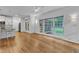 Open living room with bamboo flooring, large windows and light fixtures at 2513 Myrtle Ln, Hillsborough, NC 27278
