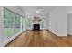 Bright living room featuring a fireplace, ceiling fan, and bamboo flooring at 2513 Myrtle Ln, Hillsborough, NC 27278