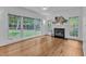 Bright living room featuring a fireplace, ceiling fan, and bamboo flooring at 2513 Myrtle Ln, Hillsborough, NC 27278