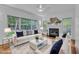 Staged living room with a fireplace, bamboo floors and light colored sofa at 2513 Myrtle Ln, Hillsborough, NC 27278