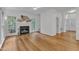 Bright living room featuring a fireplace, ceiling fan, and bamboo flooring at 2513 Myrtle Ln, Hillsborough, NC 27278