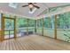 Comfortable screened porch featuring a hot tub and ceiling fan, creating a tranquil outdoor living space at 2513 Myrtle Ln, Hillsborough, NC 27278