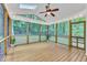 Inviting screened-in porch with a ceiling fan and string lights, perfect for relaxing and enjoying the outdoors at 2513 Myrtle Ln, Hillsborough, NC 27278