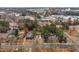 Aerial view shows a charming home nestled amongst trees and close to the city at 2515 W Club Blvd, Durham, NC 27705