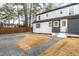 Exterior view shows a well-maintained backyard with a paved path and a white-painted home at 2515 W Club Blvd, Durham, NC 27705