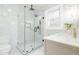 Bright bathroom featuring marble tile, glass shower, and a modern vanity with gold fixtures at 2515 W Club Blvd, Durham, NC 27705