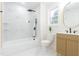 Bright bathroom featuring a modern vanity, large mirror and tiled shower-tub combination with black fixtures at 2515 W Club Blvd, Durham, NC 27705