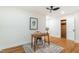 Well-lit bedroom featuring hardwood floors, rustic desk, oriental rug and a ceiling fan at 2515 W Club Blvd, Durham, NC 27705
