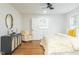 Bedroom featuring hardwood floors, modern dresser, and a comfortable seating area near the closet at 2515 W Club Blvd, Durham, NC 27705