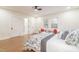 Bright bedroom featuring hardwood floors, a comfortable bed, and access to the en-suite bathroom at 2515 W Club Blvd, Durham, NC 27705